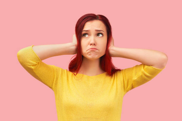 istock Young desperate annoyed woman keeps hands on head 1217844788
