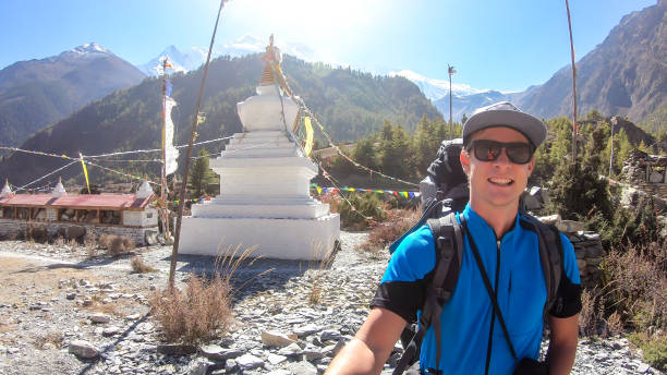 istock Ghermu - A man taking a selfie with a pagoda 1217847030