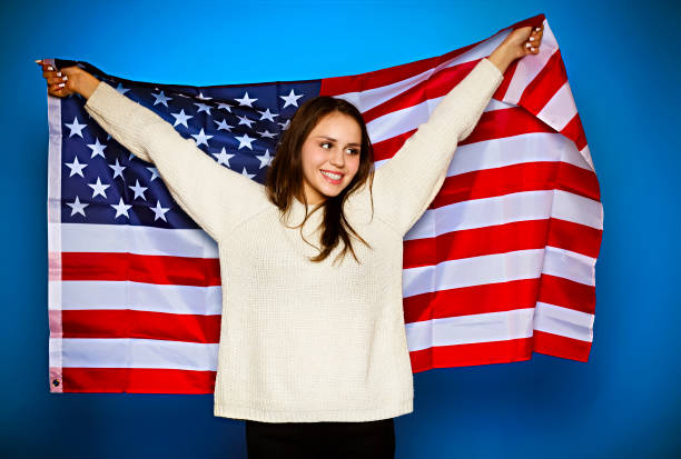 istock Young girl wrapped in american flag 1217847972