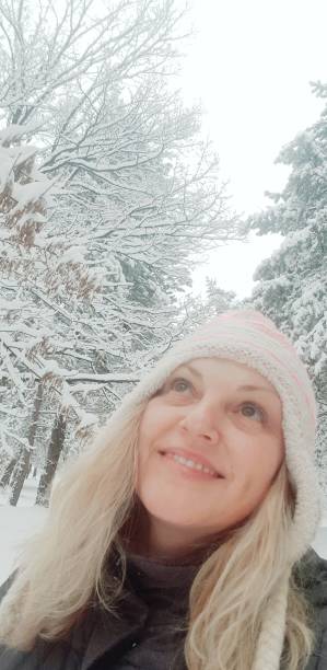 istock Woman in a snowy forest 1217848119