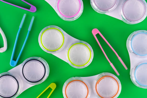 istock Background from containers for lenses. Many containers for lenses on a green background. 1217848618