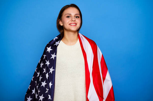 istock Young girl wrapped in american flag 1217848870