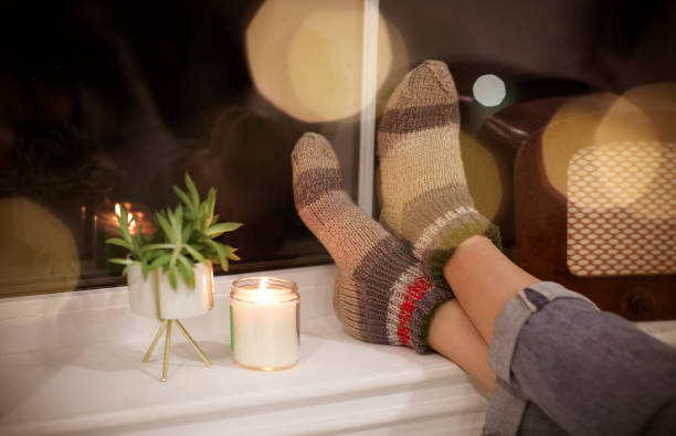 istock Anonymous young woman relaxing with hot drink in evening 1217849430