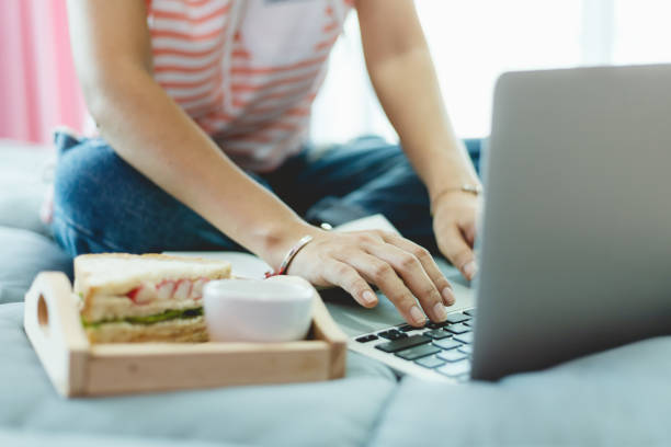 istock Woman using computer and having breakfast in bed for self-quarantine, social distancing, staying and working at home in coronavirus or Covid-2019 outbreak situation concept 1217851362
