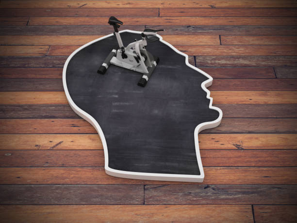 istock Human Head Shape with Training Bike on Wood Floor - 3D Rendering 1217851598