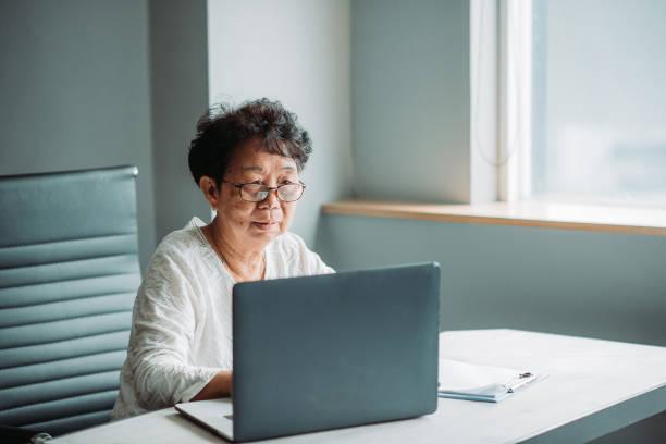istock Asian chinese active senior woman using laptop and working in her office 1217851783