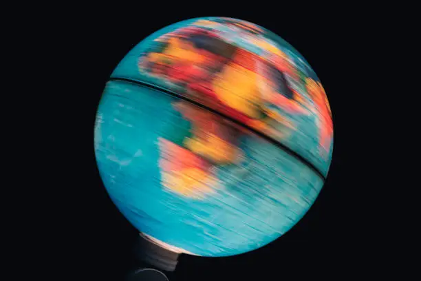 Illuminated world globe spinning with black background