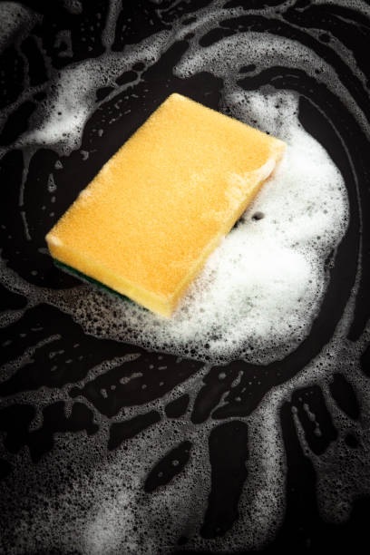 istock Close up of sponge with soap on dark surface 1217855235