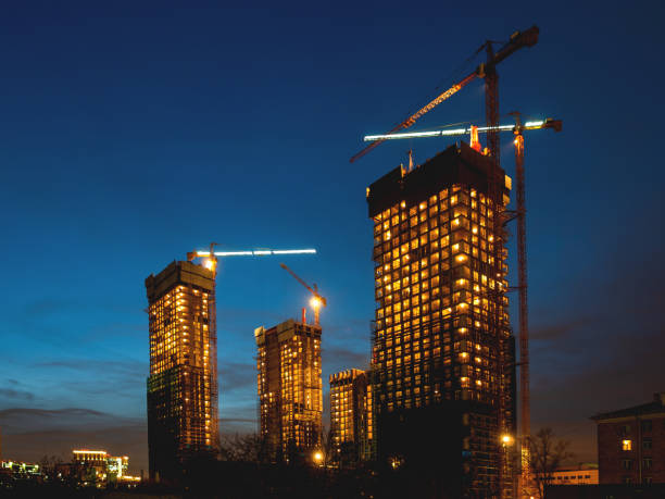Night view on construction site. Construction cranes near future high-rise apartment building. Moscow, Russia.