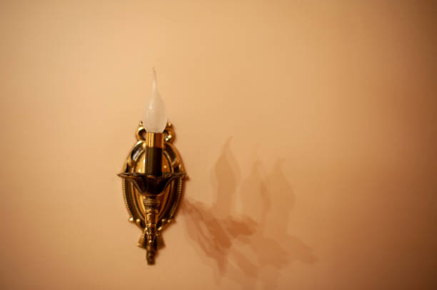 istock Glass lamp on yellow wall 1217856508