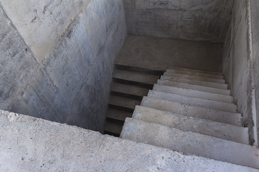 A ladder of concrete leading down. Concrete steps. Stairs down