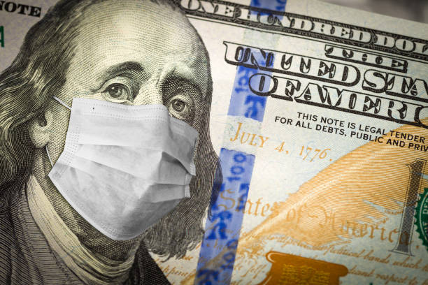 istock Benjamin Franklin With Worried and Concerned Expression Wearing Medical Face Mask On One Hundred Dollar Bill 1217857506