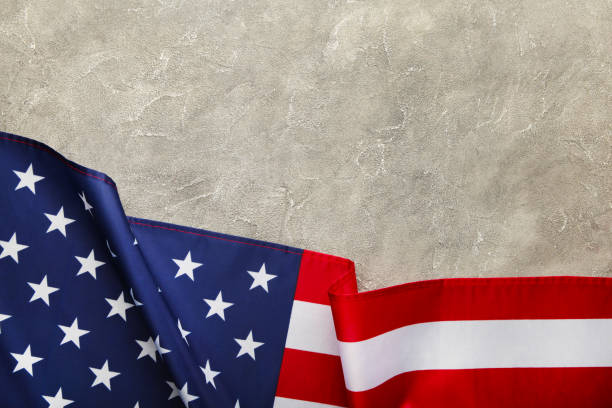 istock American flag on grey concrete background with copy space 1217857757