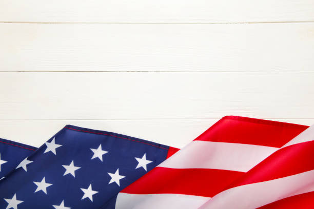 istock American flag on white wooden background with copy space 1217858084