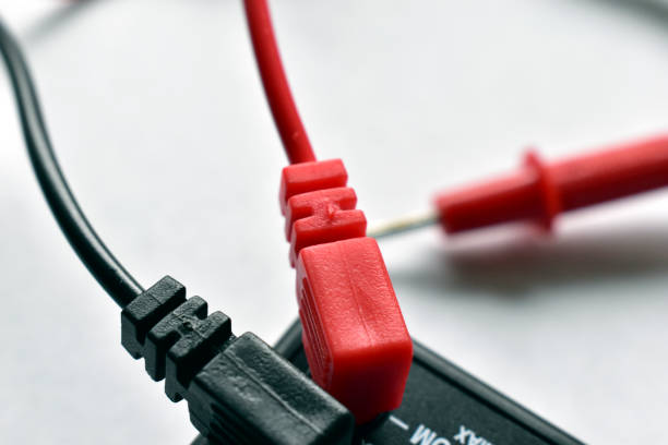 istock Red and black multimeter contacts on a white background 1217858576