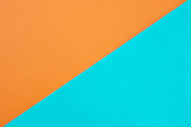 istock Background of two paper triangles, yellow and blue, connected together 1217859801