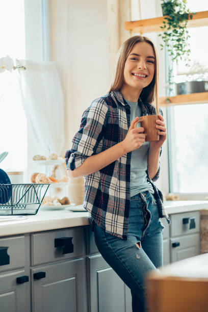 istock Beautiful smiling lady in the kitchen alone stock photo 1217860652