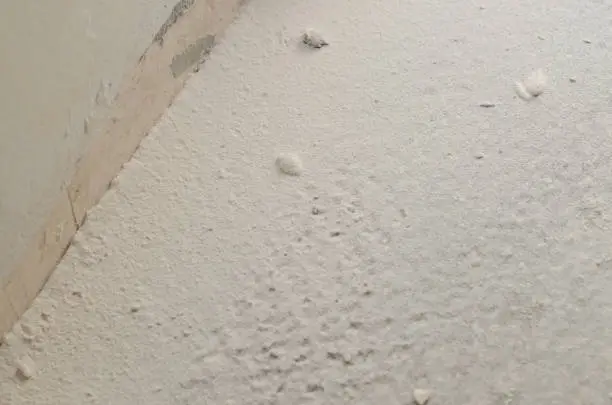 Dried putty in the form of powder on the floor