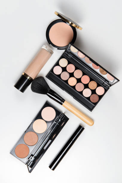 istock Makeup brushes, powder, eyeshadow palette, foundation for face tones on a white background with place for text, top view 1217860683