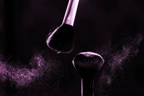 istock Powder in motion and makeup brushes close-up on a dark background 1217860736