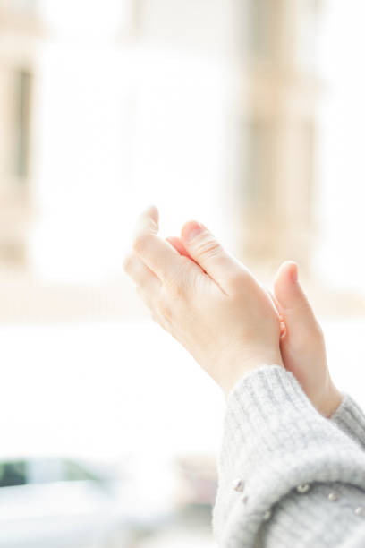 istock Spanish woman clapping by the window 1217860984