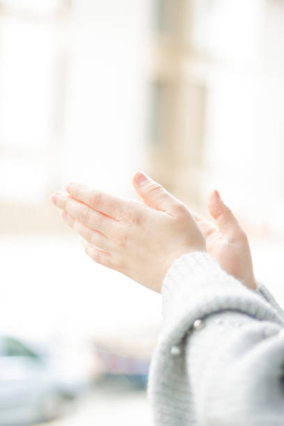 istock Spanish woman clapping by the window 1217860985