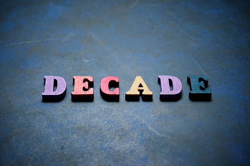 Decade word on a blue table.
