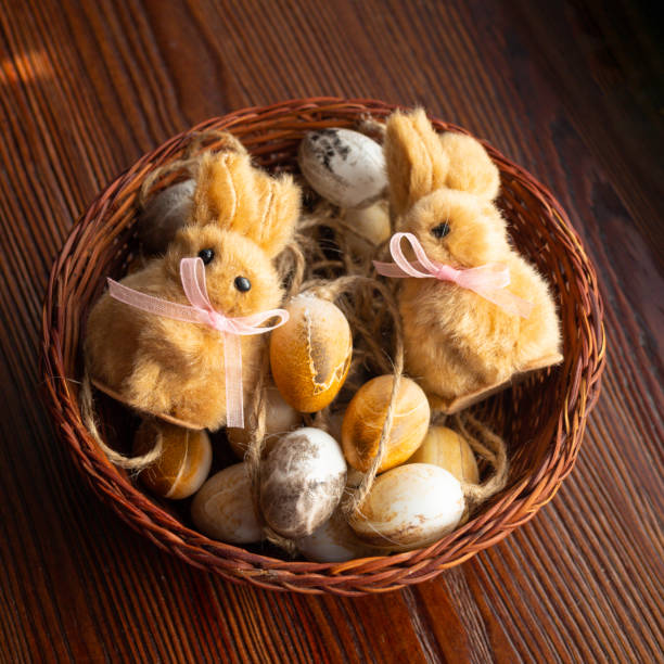 istock Nest with eggs, cute easter fluffy bunnies on wooden background 1217861436
