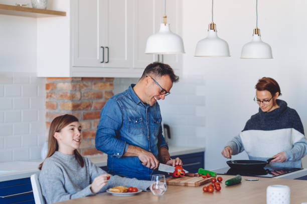 istock Mother and father preparing meal for daughter 1217861587