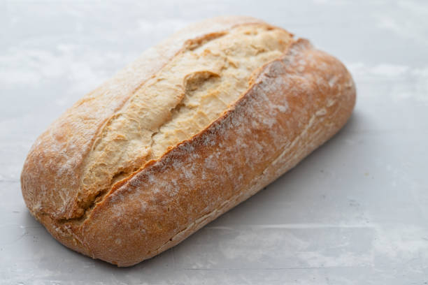 bread on gray ceramic background bread on gray ceramic background ciabatta stock pictures, royalty-free photos & images