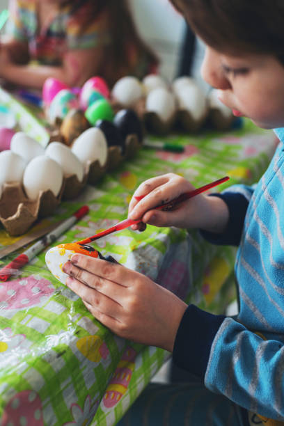 istock Brother & Sister Painting Easter Eggs 1217866221