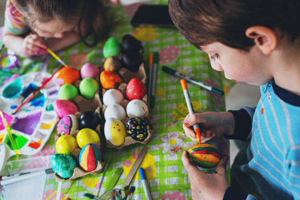 istock Brother & Sister Painting Easter Eggs 1217866336