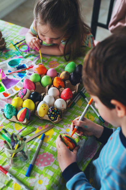 istock Brother & Sister Painting Easter Eggs 1217866351