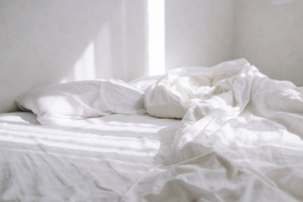 istock On a bed in a light bedroom the rays of the sun fall 1217867501
