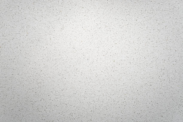 White quartz background countertop top view. White quartz background countertop. This light background is taken from a bright off-white quartz kitchen counter. The subtle texture can be used as surface or table backdrop graphic design element. table top view stock pictures, royalty-free photos & images