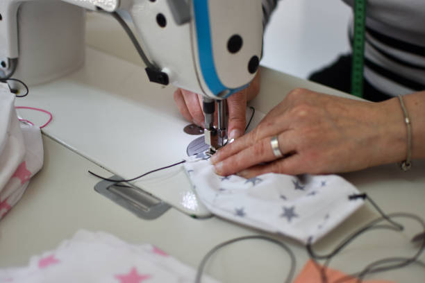 istock Woman sewing homemade protective mask 1217870723