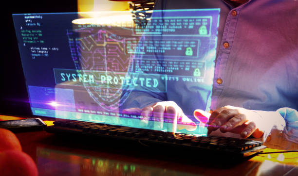 istock Man typing on keyboard with security shield symbol hologram screen 1217870872