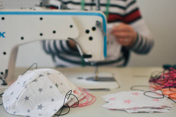 istock Woman sewing homemade protective mask 1217871045