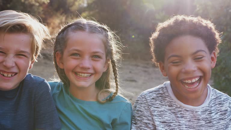 Portrait Of Multi-Cultural Children Hanging Out With Friends In Countryside Together