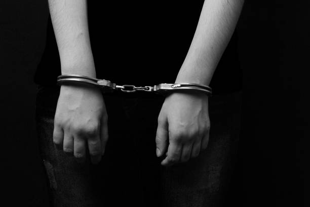 istock men and women cuffed hands together 1217871554