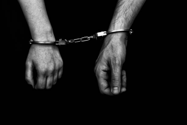 istock men and women cuffed hands together 1217872408