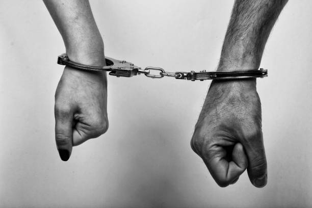 istock men and women cuffed hands together 1217872681