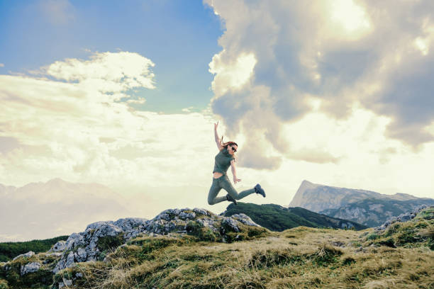 istock Young woman jumping in a mountain 1217873056