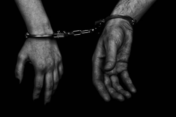 istock men and women cuffed hands together 1217873057