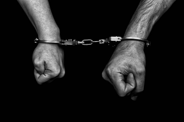 istock men and women cuffed hands together 1217873292