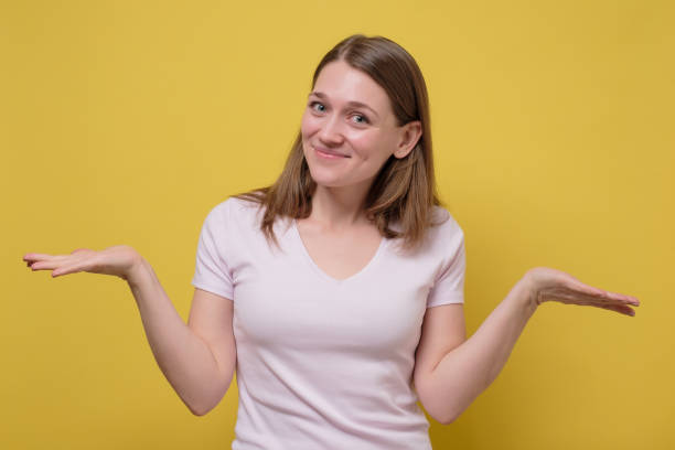 istock woman showing two empty copy spaces, make decision between alternative products 1217874260