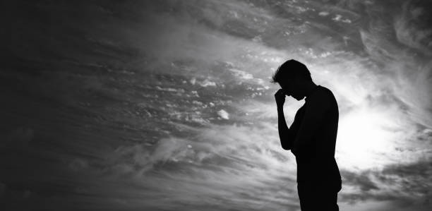Silhouette of sad unrecognizable man. Stressed, sadness concept. facepalm stock pictures, royalty-free photos & images