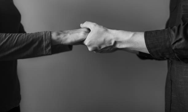 istock Man and woman holding hands on isolated background. 1217874641