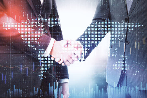istock Businesspeople shaking hand and glowing global  financial statistic 1217874698