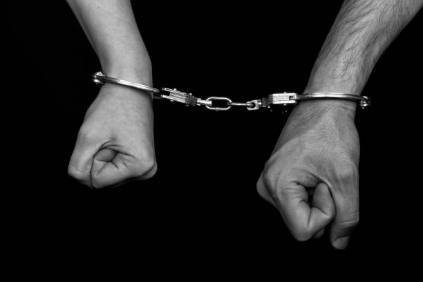 istock men and women cuffed hands together 1217874725